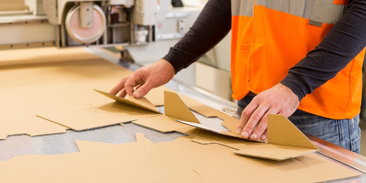 Corrugated boxes being printed and cut